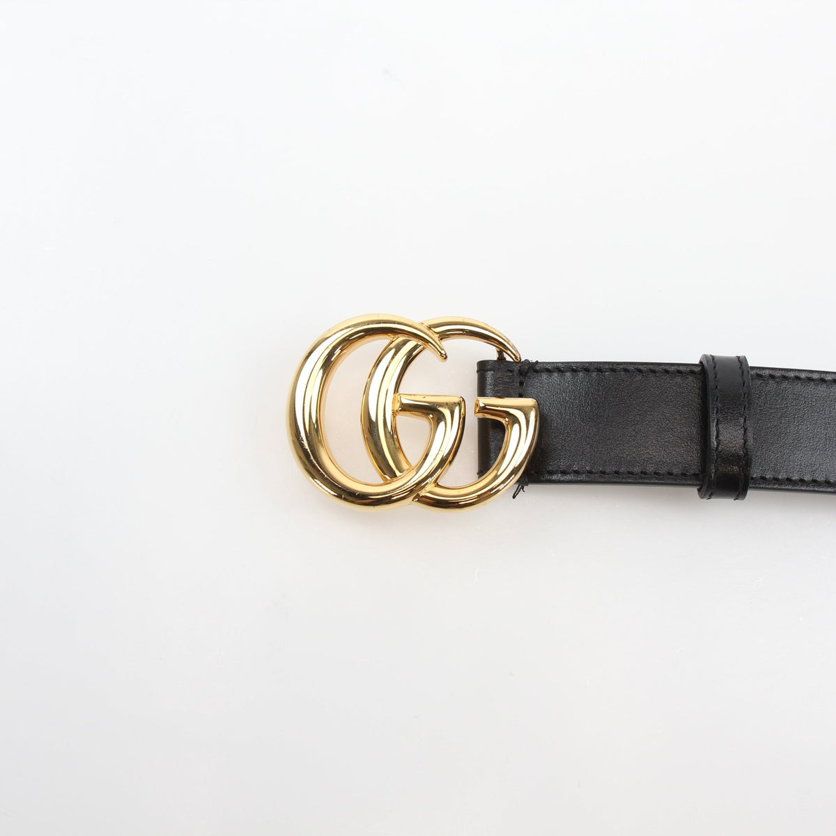 Black leather Gucci GG Marmont thin belt with gold-tone hardware, stylish accessory for various outfits.