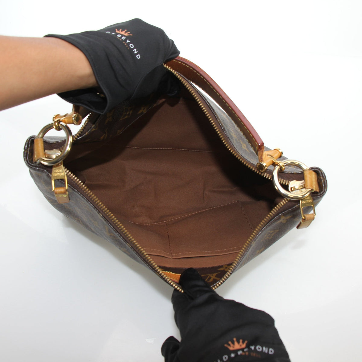 Louis Vuitton Sully MM monogram hobo shoulder bag featuring leather trim and gold-tone hardware, displayed on a plain background.