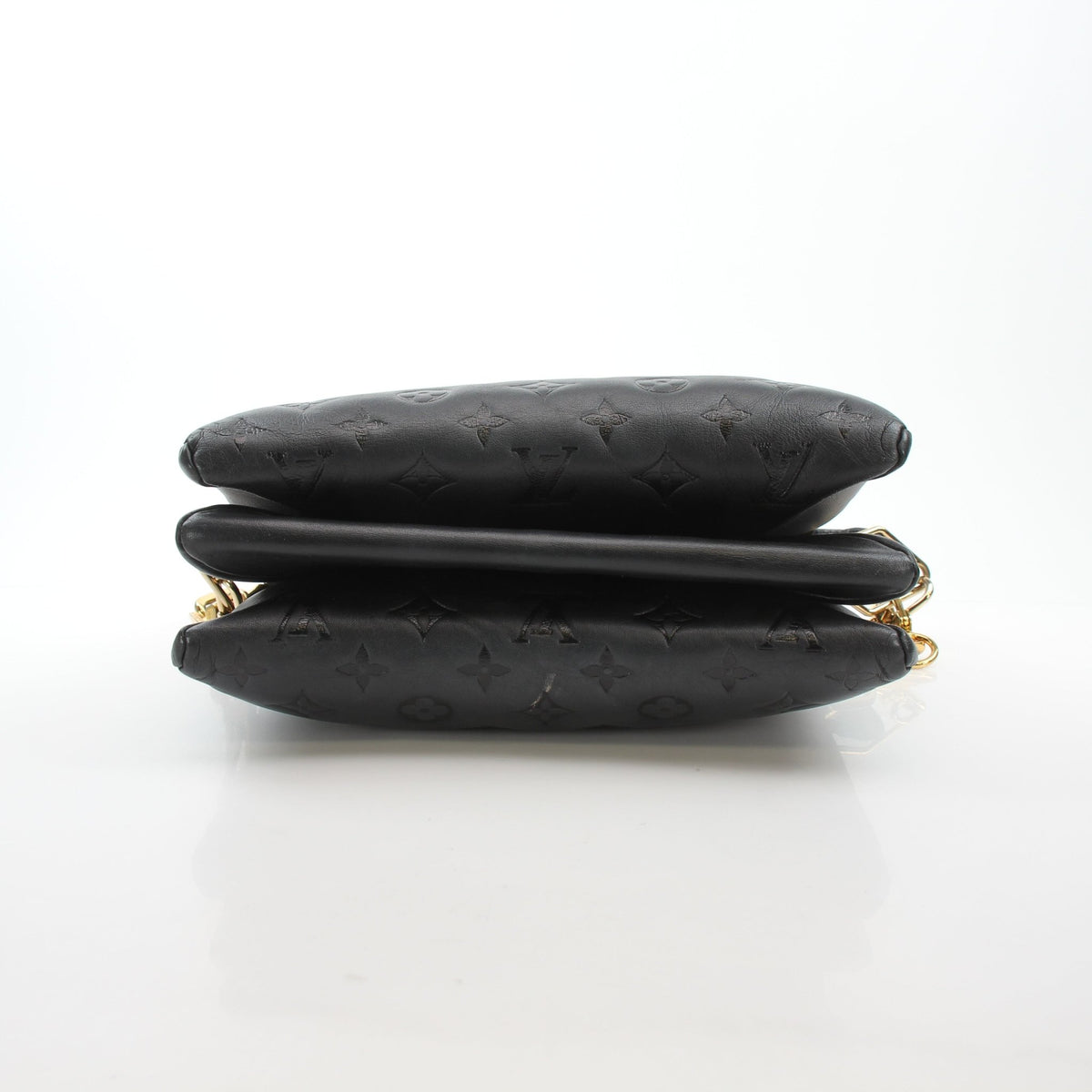 Louis Vuitton Black Coussin PM handbag with gold hardware, soft leather and quilted design, displayed on a neutral background.