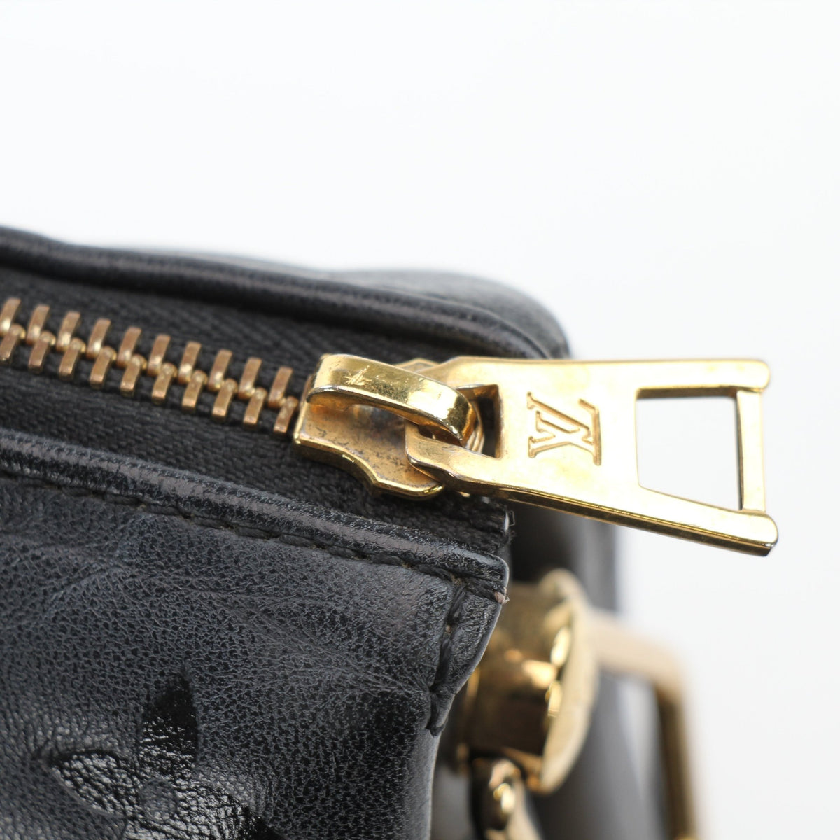 Louis Vuitton Black Coussin PM handbag with gold accents, featuring soft padded design and elegant shape.