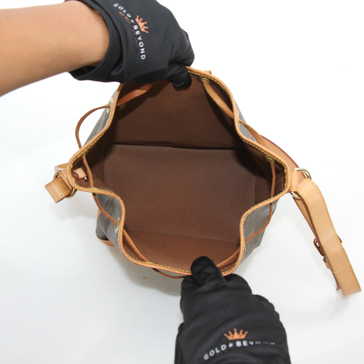 Louis Vuitton Noé BB Monogram Bucket Bag with gold-tone hardware and leather drawstrings, displayed on a plain background.