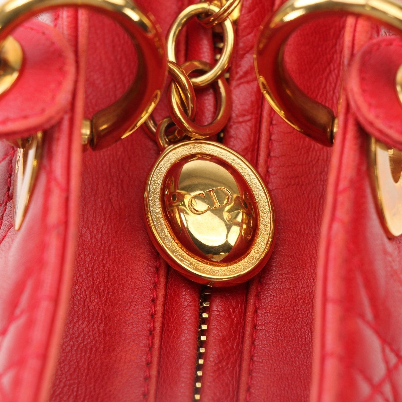 Christian Dior Lady Dior red leather handbag with top handle and gold accents, stylish and elegant for everyday use