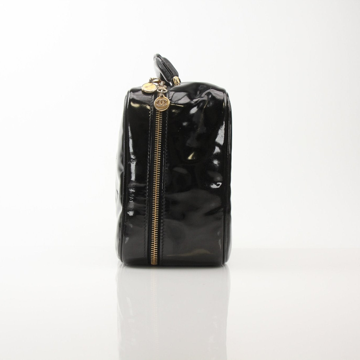 Gold & Beyond Chanel Coco Mark patent 2-way handbag with gold accents and quilted design, shown from a front angle.