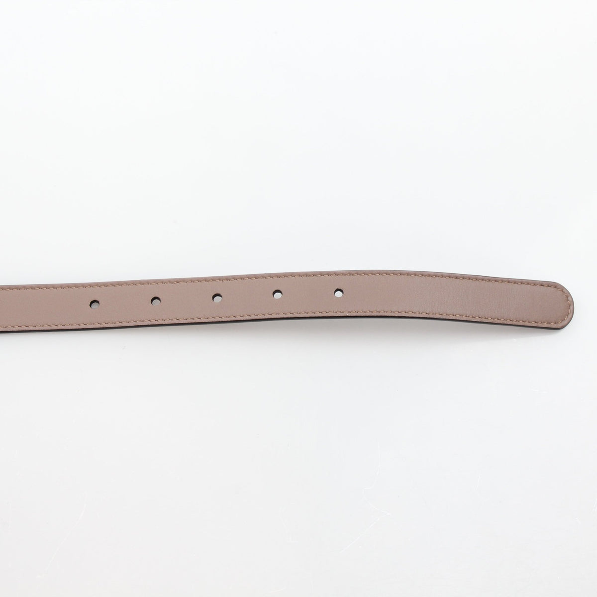 Taupe Gucci GG Marmont thin leather belt with gold-tone buckle, displayed on a neutral background.