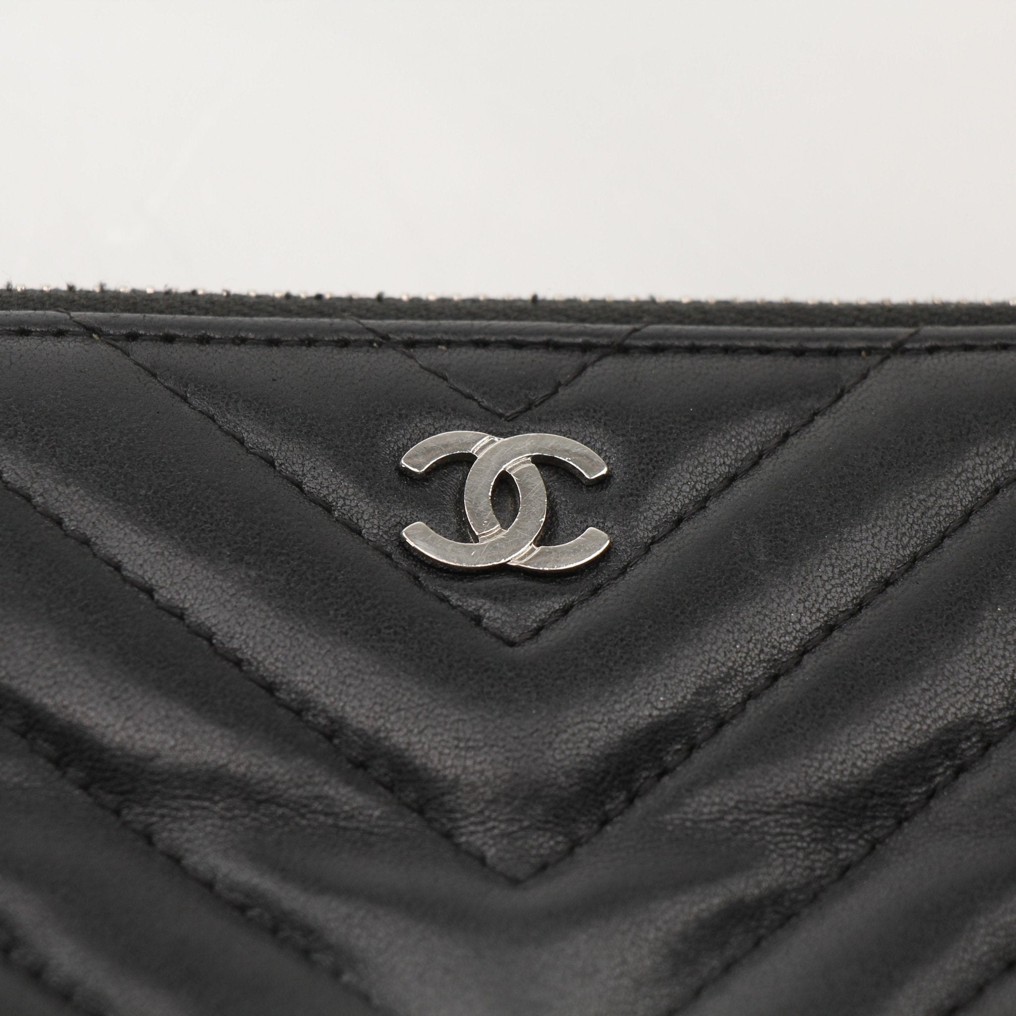 Chanel V-Stitch Chevron Lambskin 2-Way Chain Bag, elegant black handbag with gold chain strap and quilted leather design.