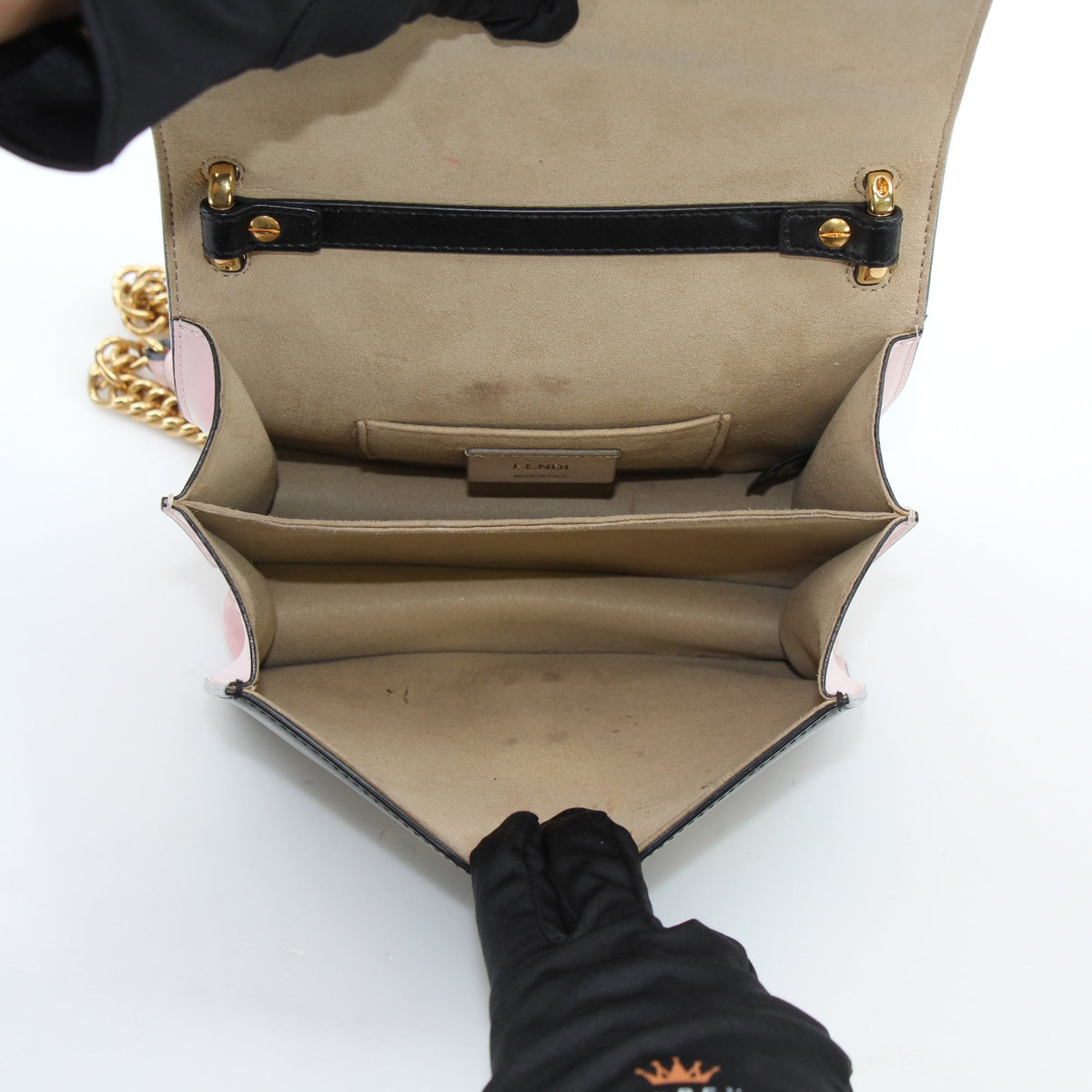 Fendi x FILA Fendi Mania small Kan I shoulder handbag in vibrant colors with logo details, carried by a hand.