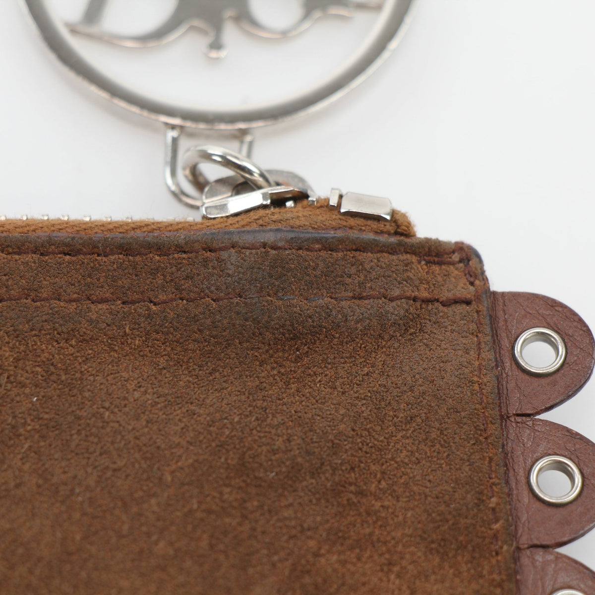 Christian Dior Peace & Love suede clutch handbag in brown with gold accents, featuring a sleek, compact design and textured surface.