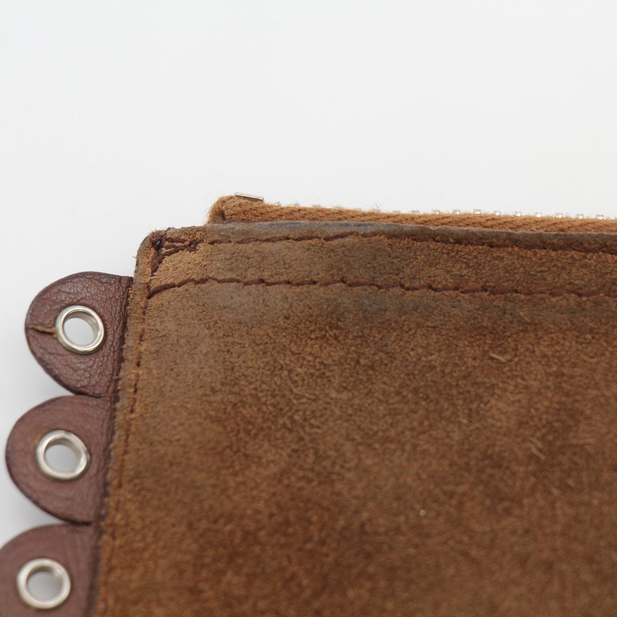 Brown Christian Dior Peace & Love suede clutch handbag with gold accents, featuring a stylish and compact design.