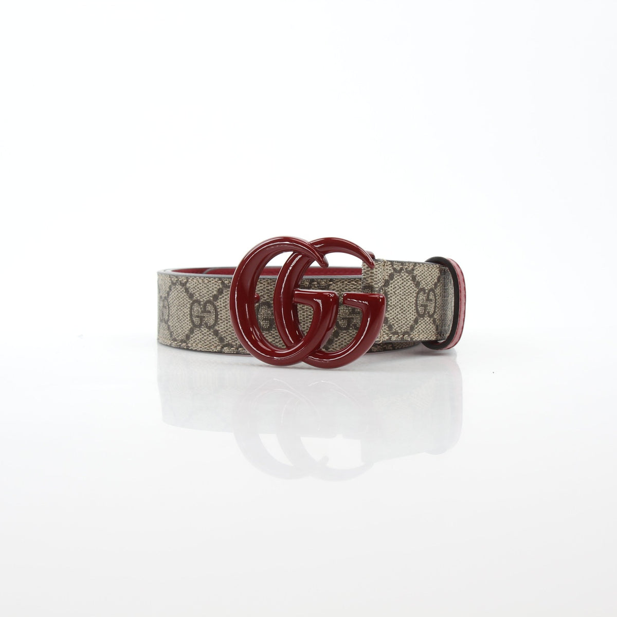 Gucci Double G belt in beige and ebony with red accents, displayed as a stylish accessories piece on a neutral background.