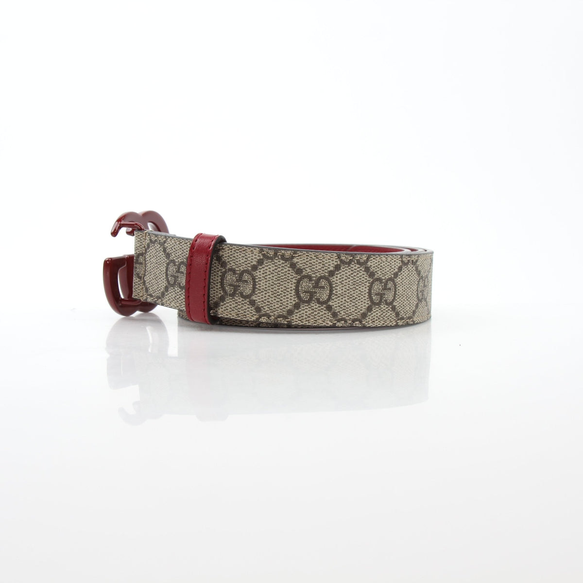 Gucci Double G belt in beige and ebony with red accents, stylish accessories featuring iconic logo design.
