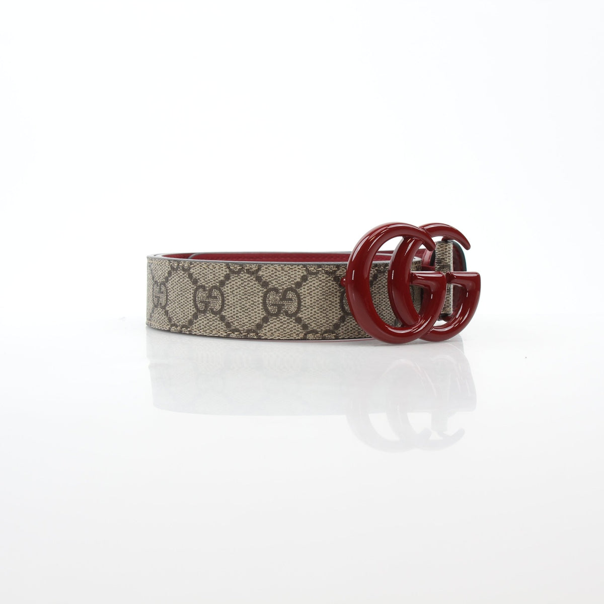 Gucci Double G belt in beige ebony with red accents, featuring gold hardware, displayed on a neutral background.