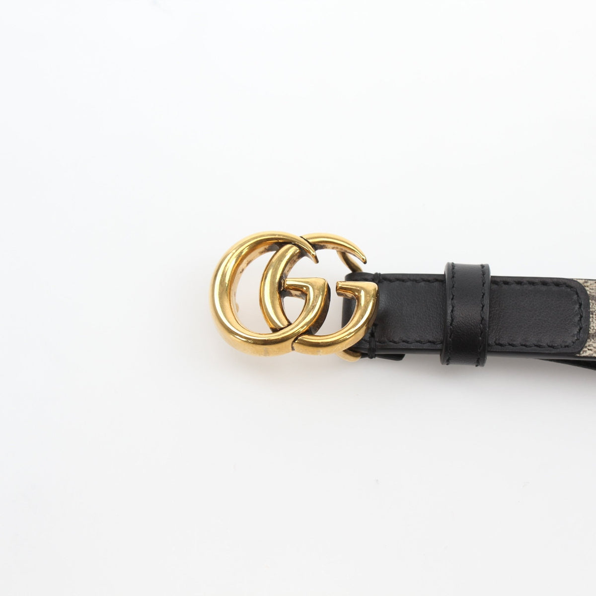 Reversible Gucci GG Supreme Marmont belt with beige and black leather, stylish accessories featuring the iconic design.