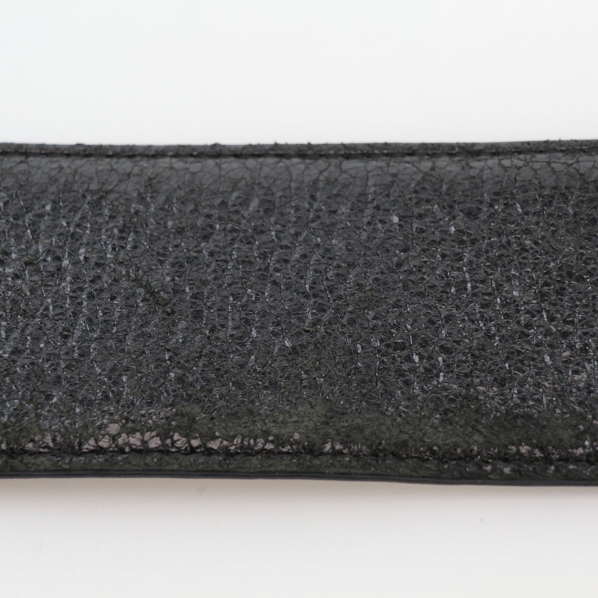 Black grained calfskin leather Christian Dior Cause Bee oval buckle belt with gold hardware, displayed on a handbag.