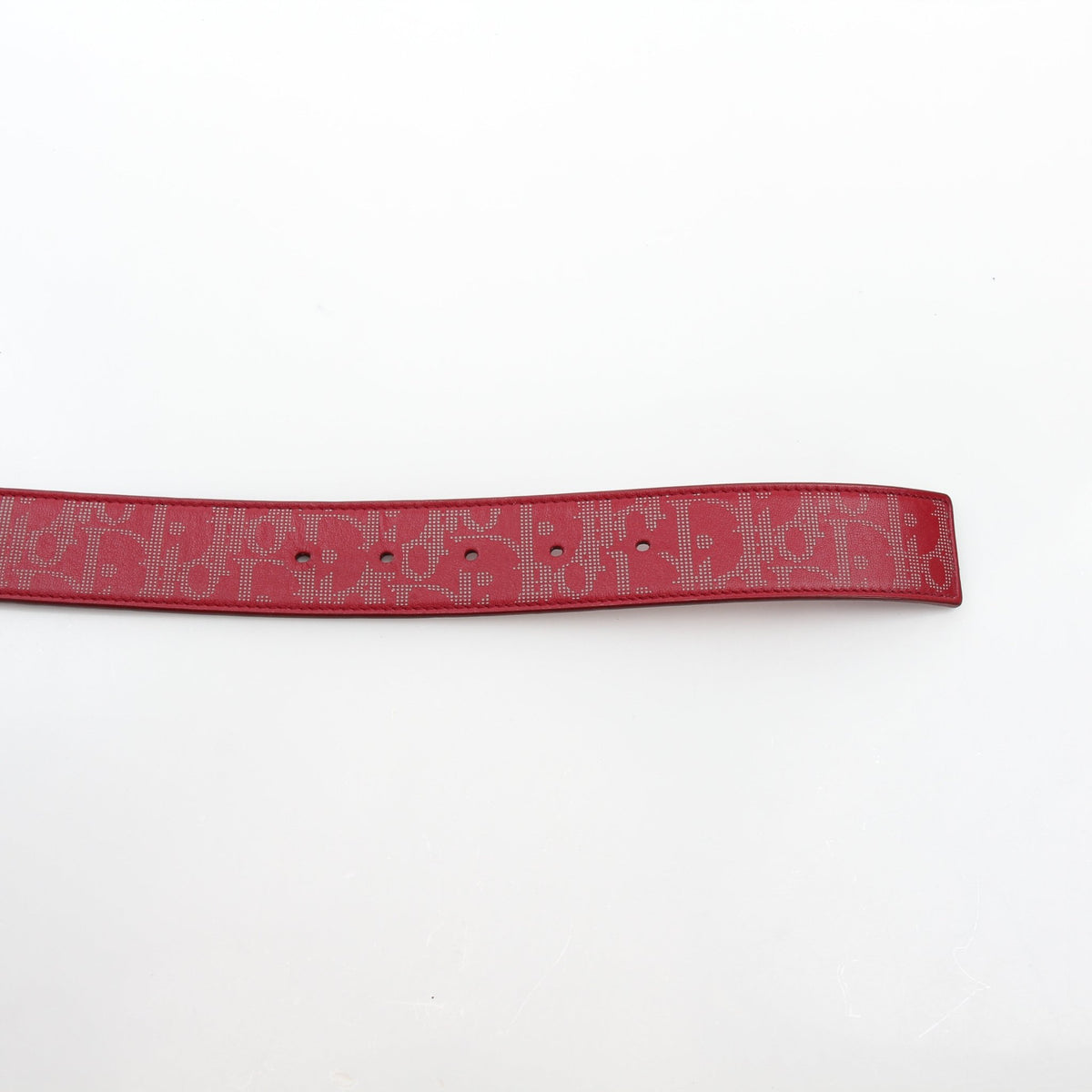 Christian Dior World Tour Oblique Galaxy reversible belt in red calfskin leather, showcasing the designer brand’s signature pattern and craftsmanship.