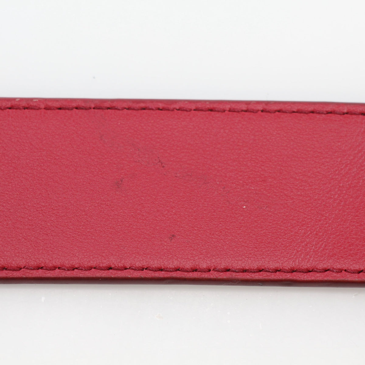Christian Dior World Tour Oblique Galaxy reversible belt in red calfskin leather, featuring gold accents and intricate branding details.
