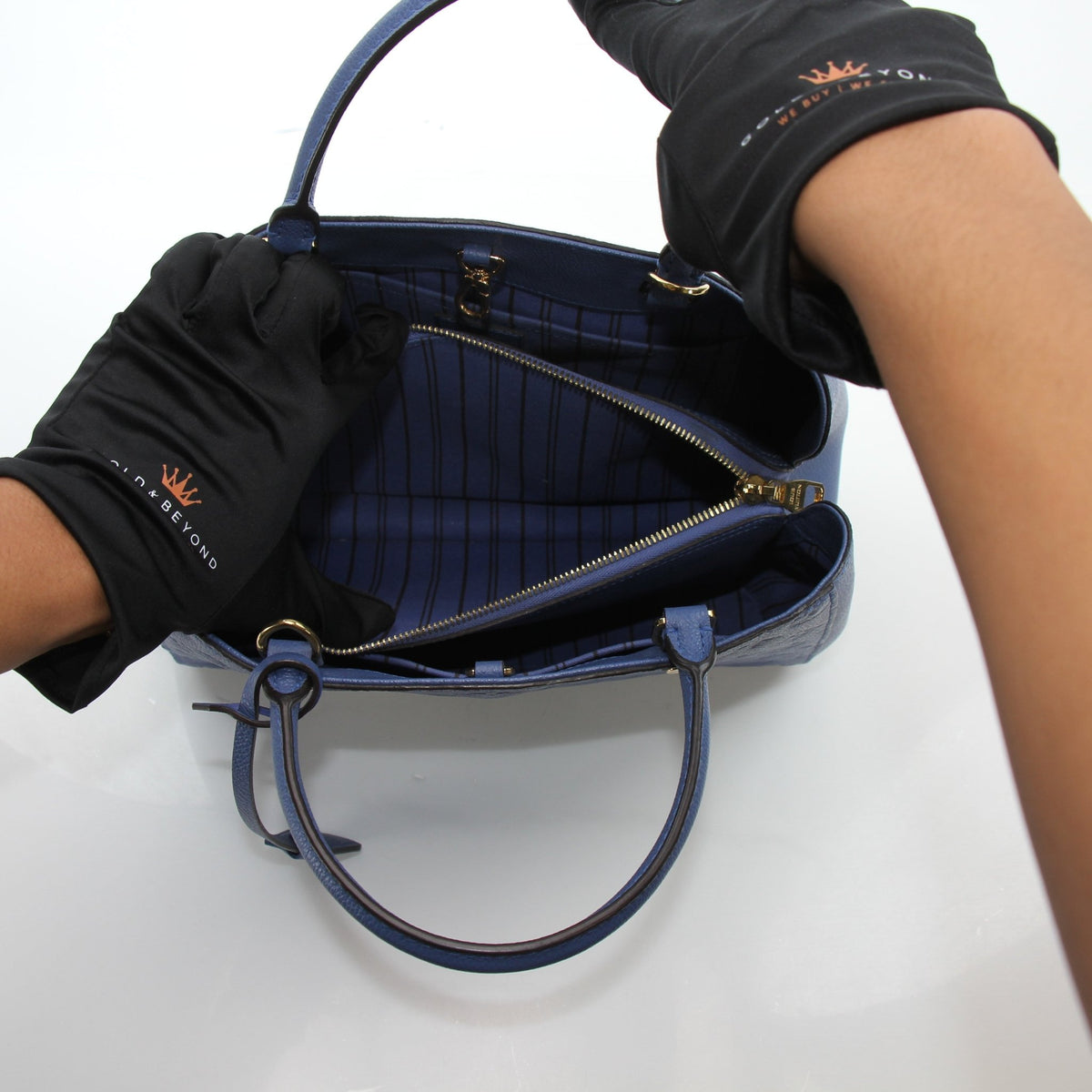 Louis Vuitton Montaigne MM Monogram Empreinte leather handbag in blue with gold hardware and dual top handles.