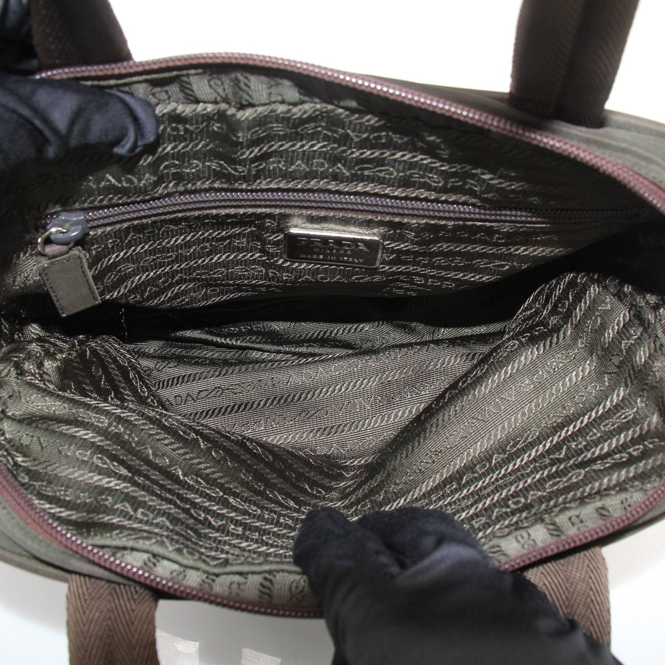 Prada olive green triangle logo satchel handbag with gold accents, featuring a structured design and top handle.