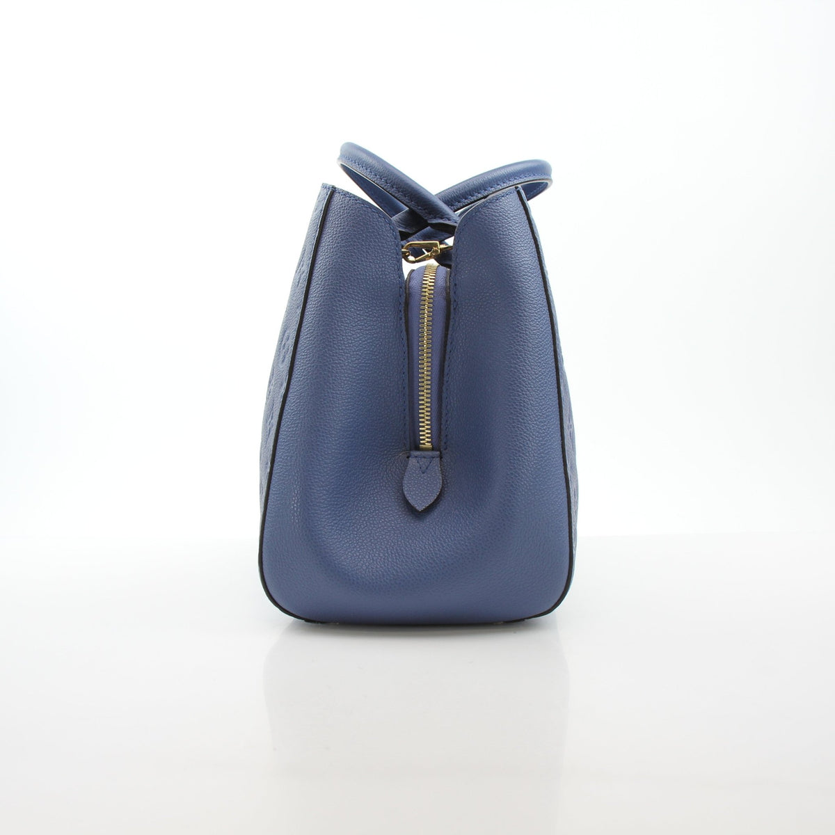 Louis Vuitton Montaigne MM Monogram Empreinte leather handbag in blue, featuring gold hardware and structured design.