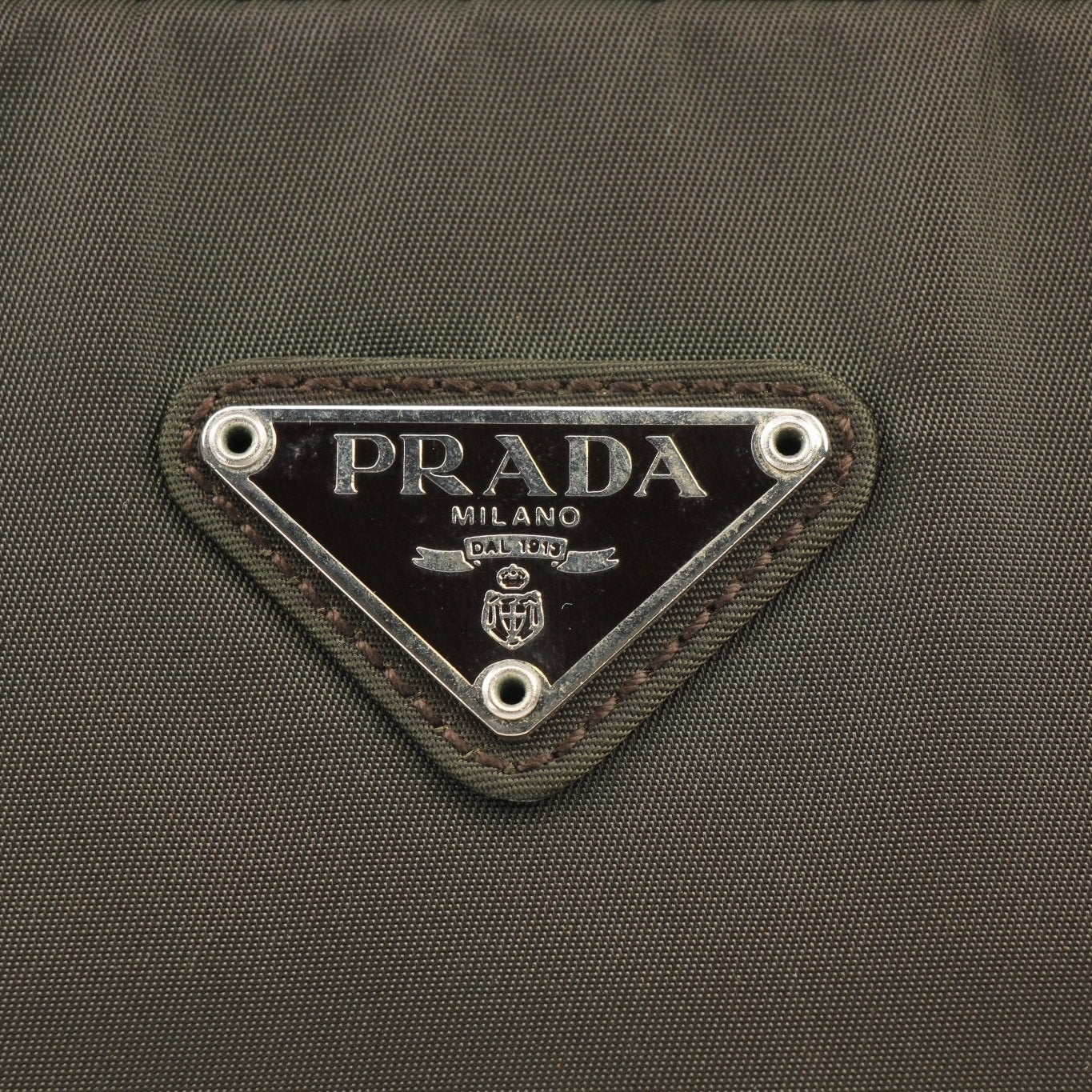 Prada olive green triangle logo satchel handbag with gold hardware and top handles, stylish and elegant accessory.