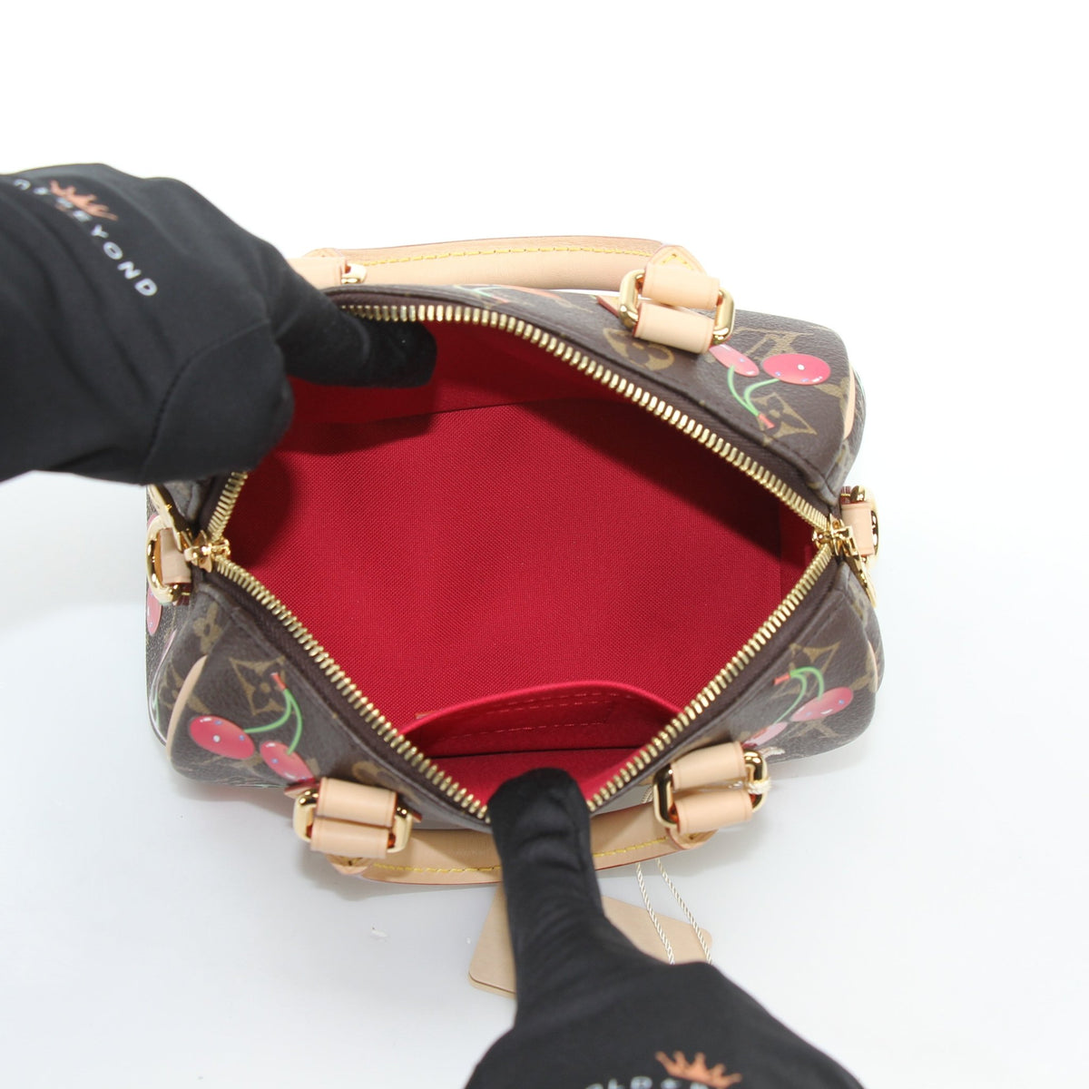 Louis Vuitton x Takashi Murakami Monogram Cerises Speedy Bandoulière 20 handbag with colorful cherry print and gold hardware.