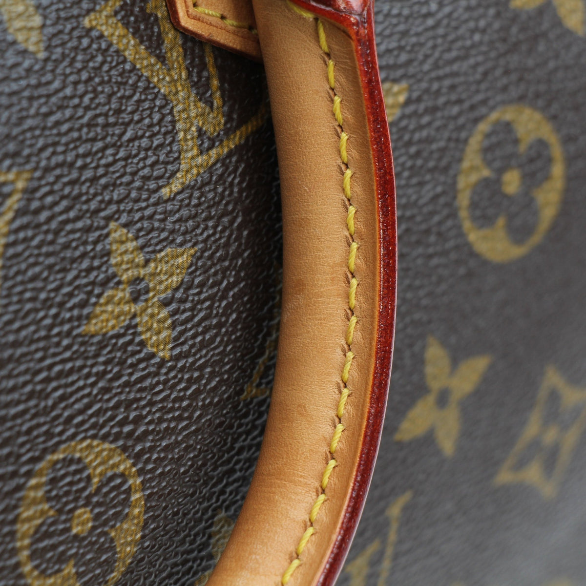 Louis Vuitton Speedy Bandoulière 30 handbag with gold-tone hardware and leather handles, shown from a front angle.
