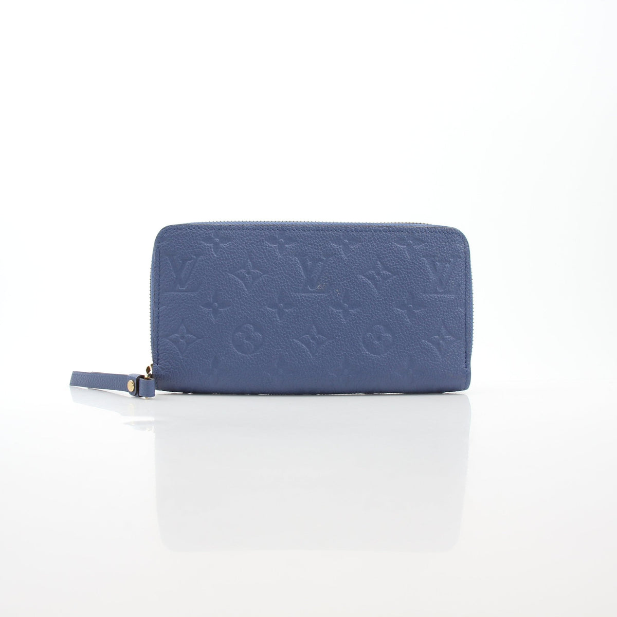 Louis Vuitton Monogram Empreinte Zippy Wallet in Bleu Infini with gold hardware, showcasing embossed leather and multiple card slots.