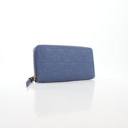 Louis Vuitton Monogram Empreinte Zippy Wallet in Bleu Infini with gold accents, featuring multiple card slots and a zippered coin compartment.