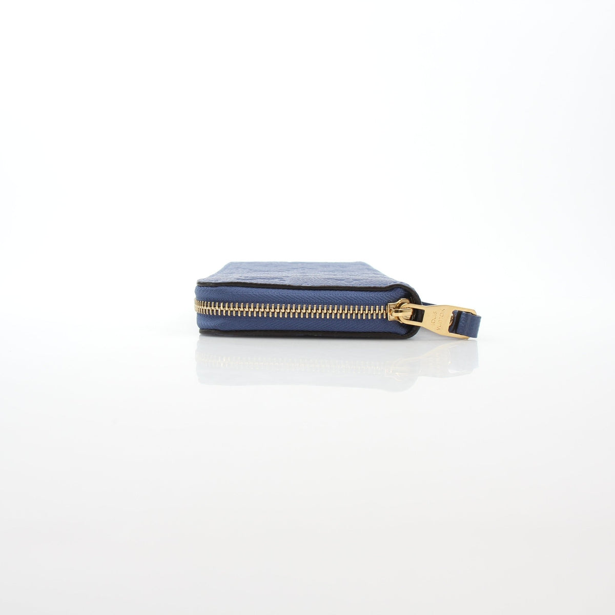 Louis Vuitton Monogram Empreinte Zippy Wallet in Bleu Infini with gold-tone zipper and embossed details, crafted from premium leather.