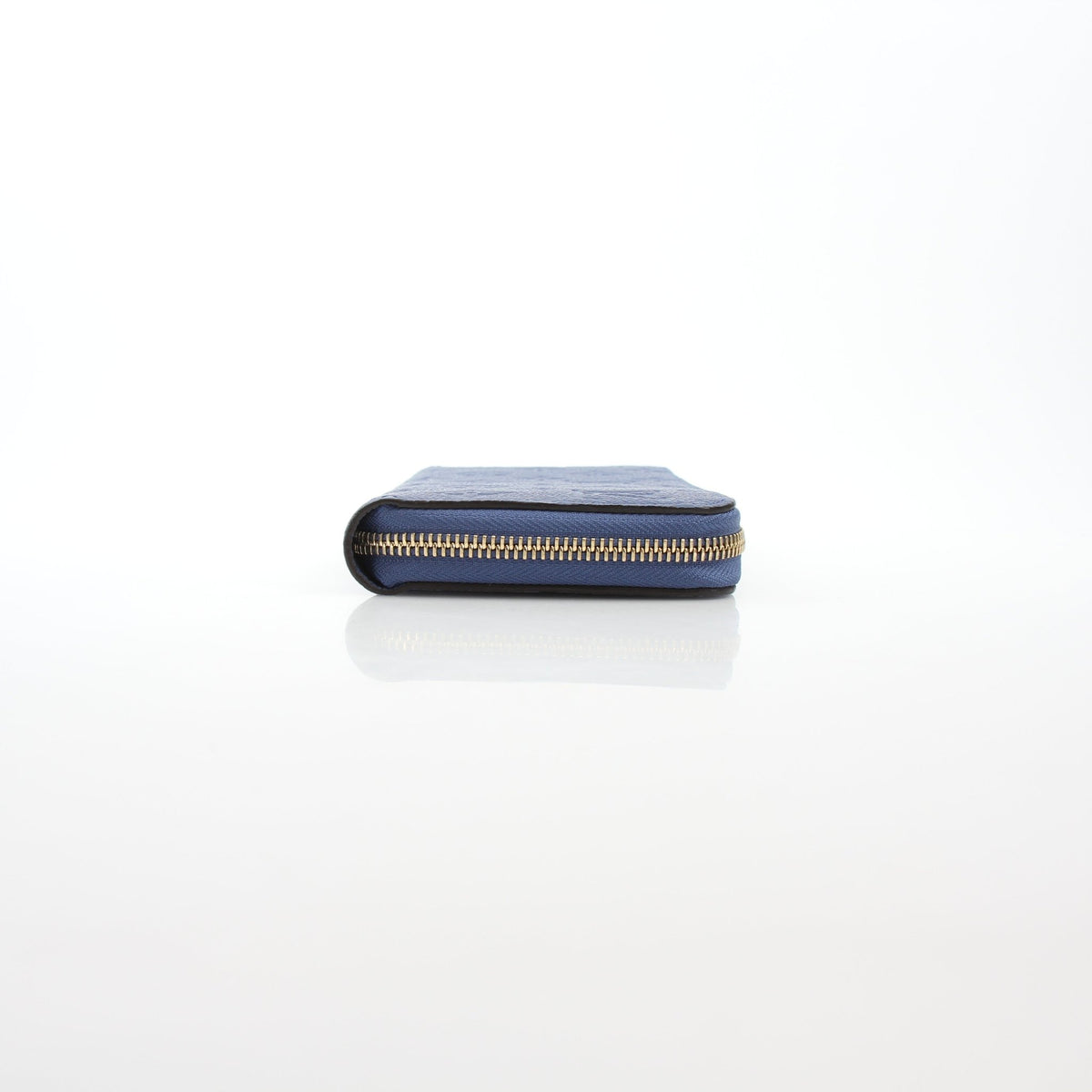 Louis Vuitton Monogram Empreinte Zippy Wallet in Bleu Infini with gold hardware and embossed LV logo, featuring multiple card slots.