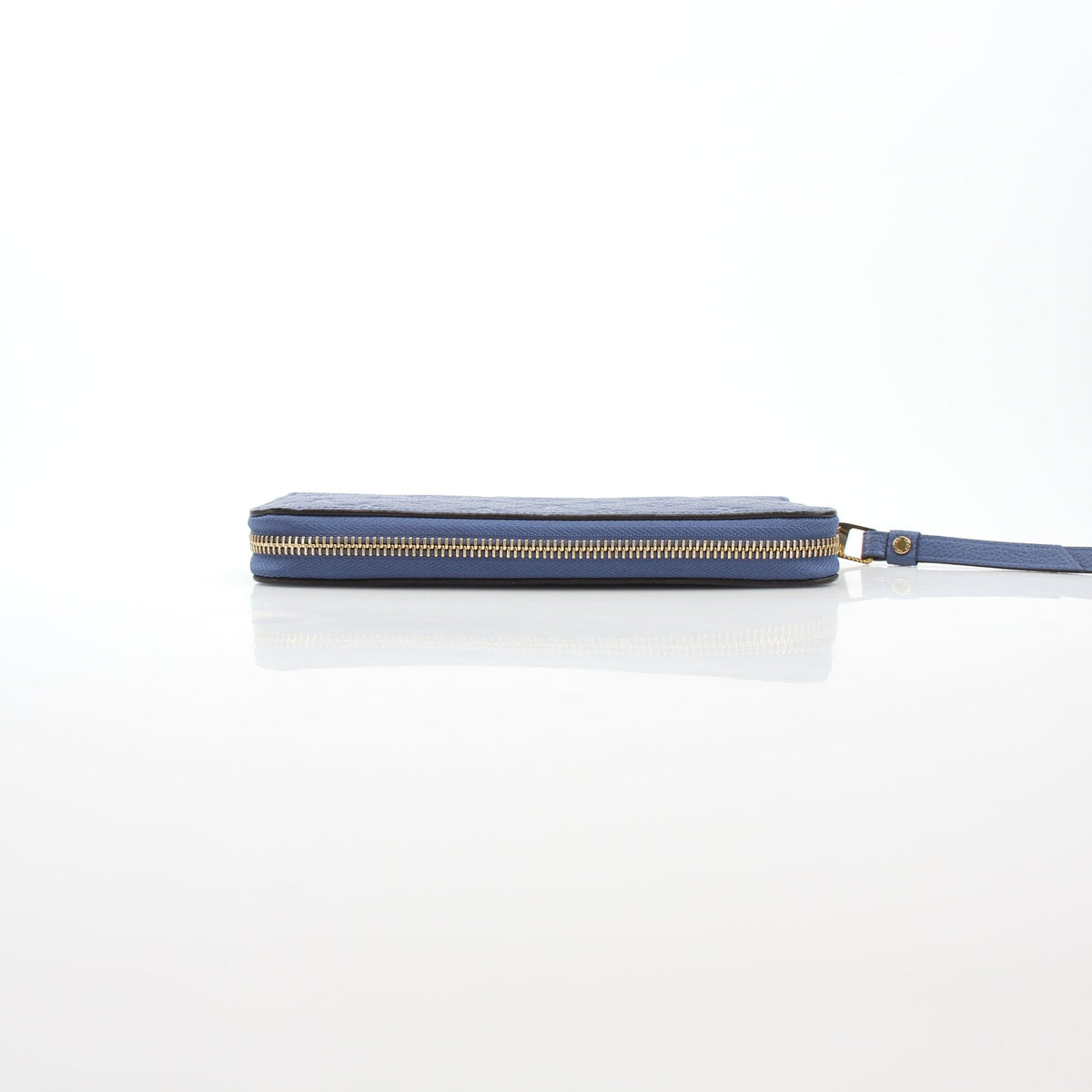 Louis Vuitton Monogram Empreinte Zippy Wallet in Bleu Infini leather with gold-tone hardware and embossed LV logo.