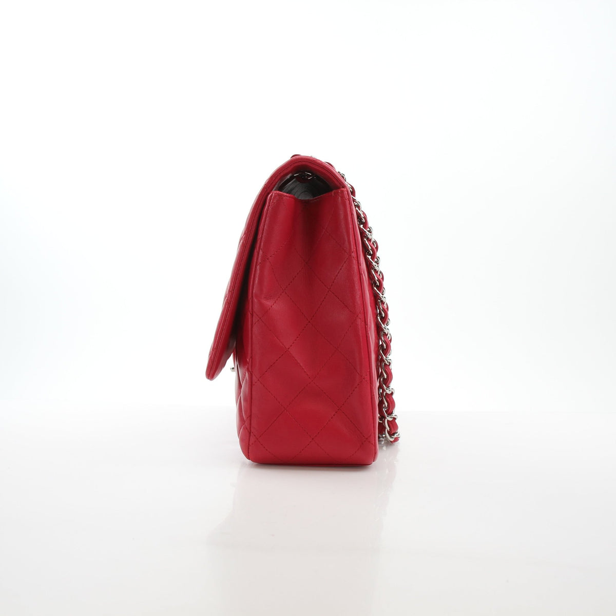 Chanel Classic Maxi Double Flap Red Lambskin Shoulder Bag with gold hardware, showcasing its elegant design and luxurious texture.