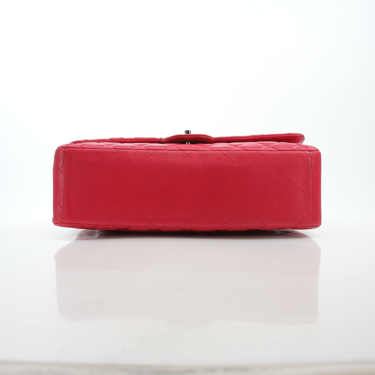 Chanel Classic Maxi double flap red lambskin shoulder handbag with gold hardware, featuring quilted design and chain strap.