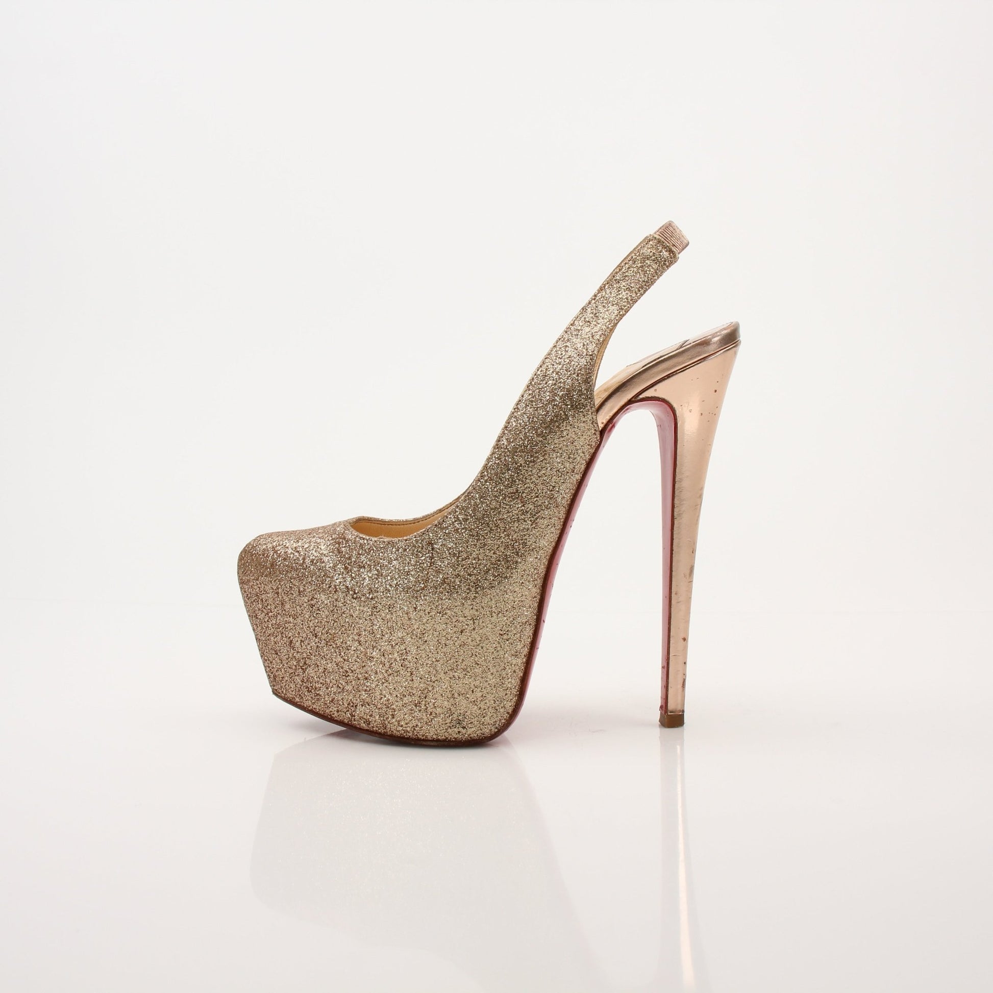 Christian Louboutin Daffodil sling heels with red soles, featuring sleek design and elegant straps, displayed on a neutral background.