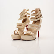 Gold & Beyond Christian Louboutin Differa 140 heels featuring sleek black patent leather and signature red soles.