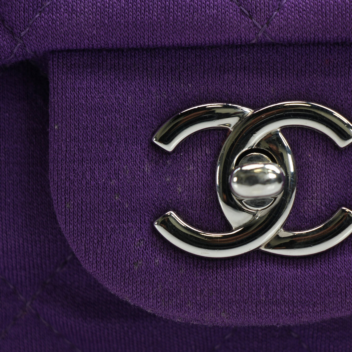 Chanel Classic Jumbo purple quilted jersey shoulder handbag with gold hardware and single flap, featuring signature quilting and chain strap.