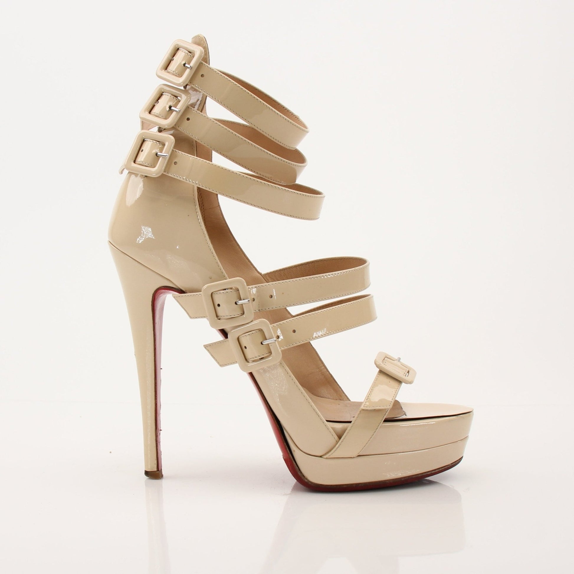 Christian Louboutin Differa 140 heels with gold accents, featuring sleek design and pointed toes, displayed on a neutral background.