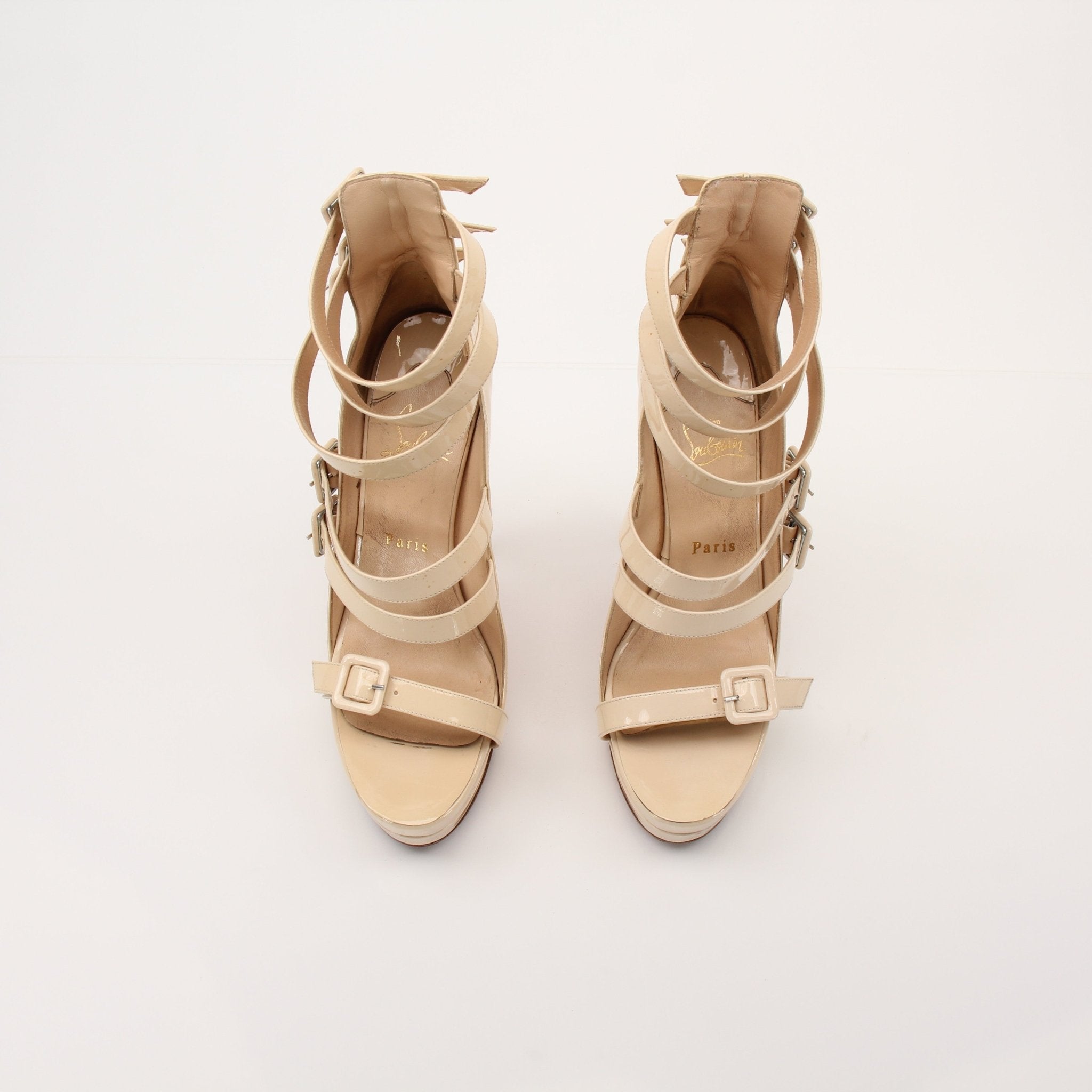 Gold & Beyond Christian Louboutin Differa 140 heels with red soles, elegant stiletto design, and sleek black leather finish.