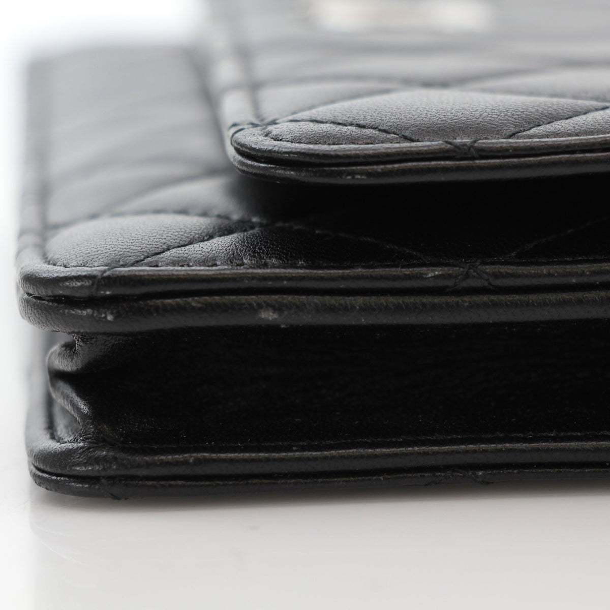 Black quilted lambskin Chanel Crystal Star Wallet on Chain handbag with gold accents, featuring a luxurious chain strap.