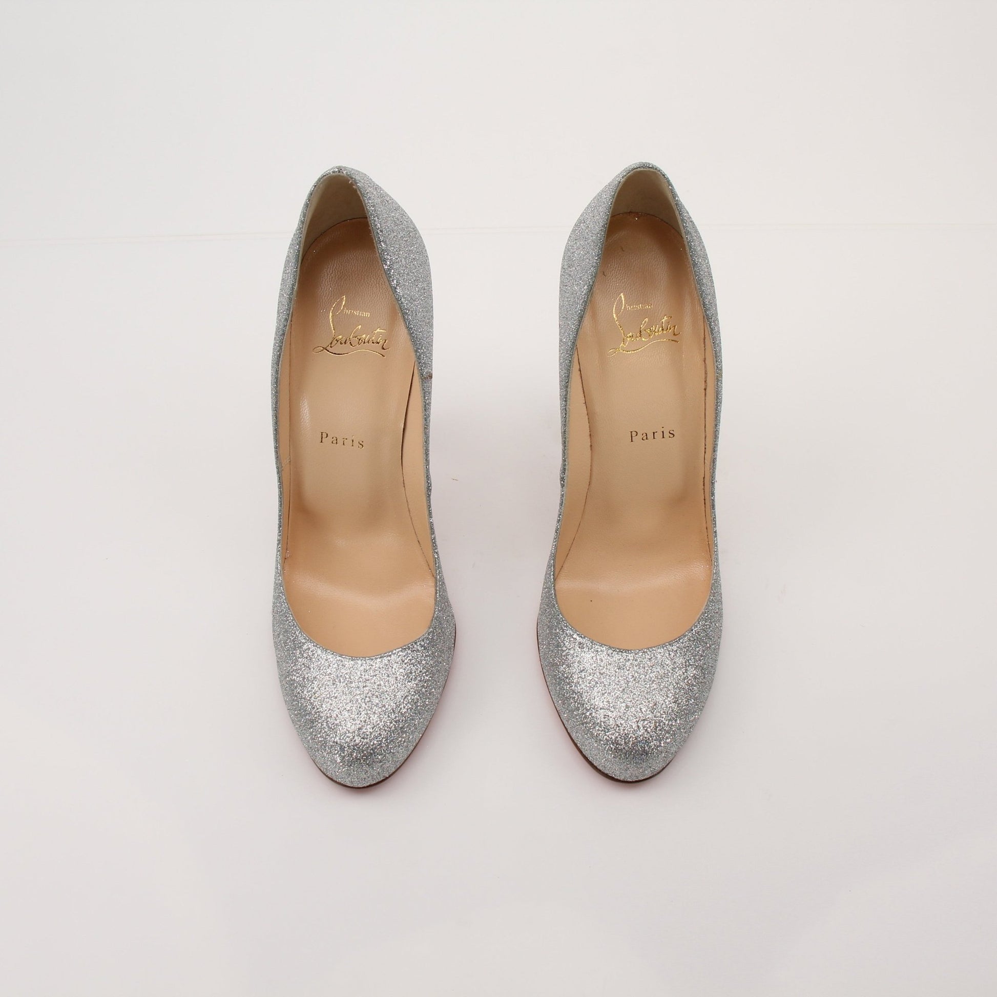 Christian Louboutin Fifille pump heels with red sole and sleek design, showcased in a stylish setting.