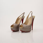 Gold & Beyond Christian Louboutin glitter slingback heels with pointed toes and elegant design, showcasing luxurious footwear style.