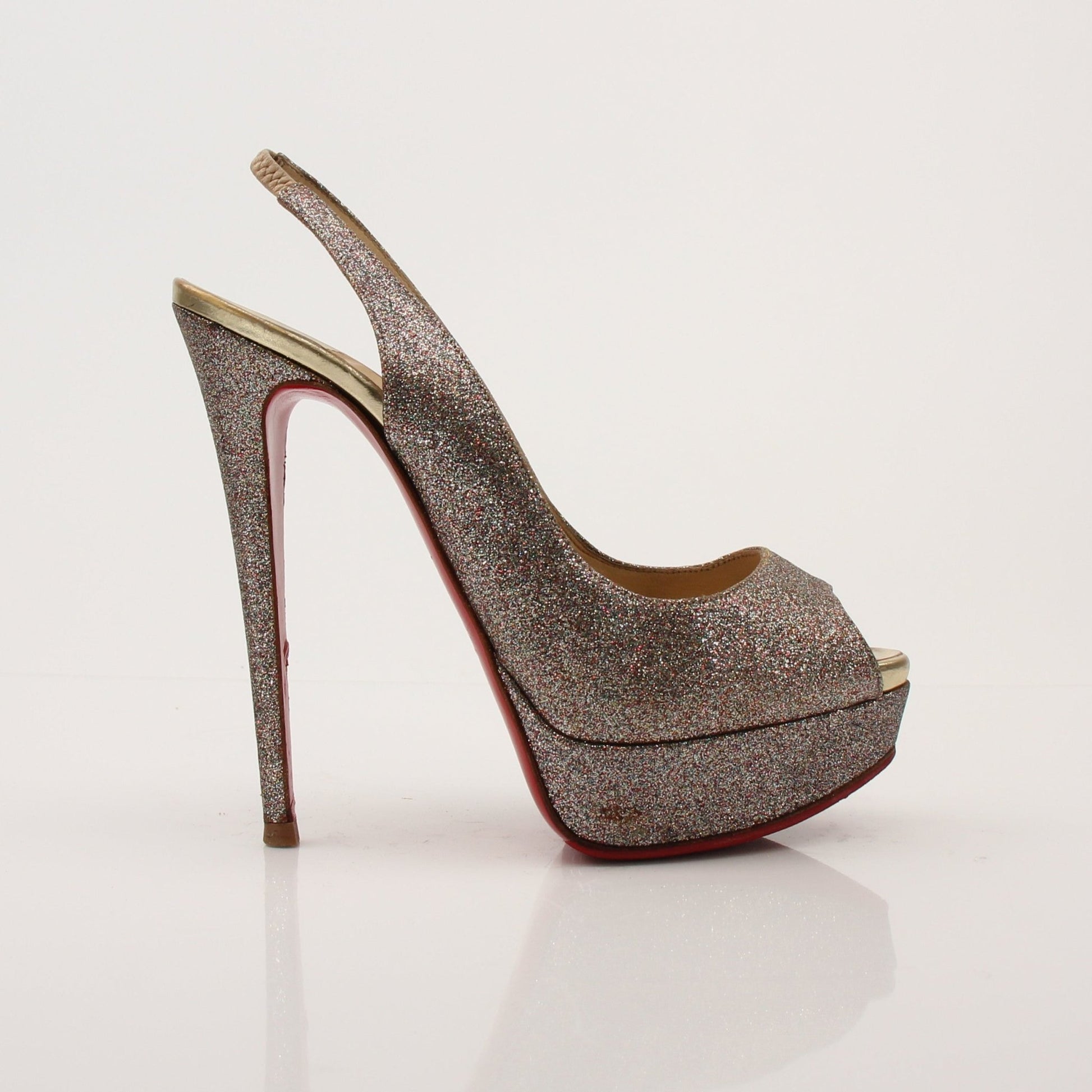 Gold & Beyond Christian Louboutin glitter slingback heels with pointed toes and elegant design on a white background.