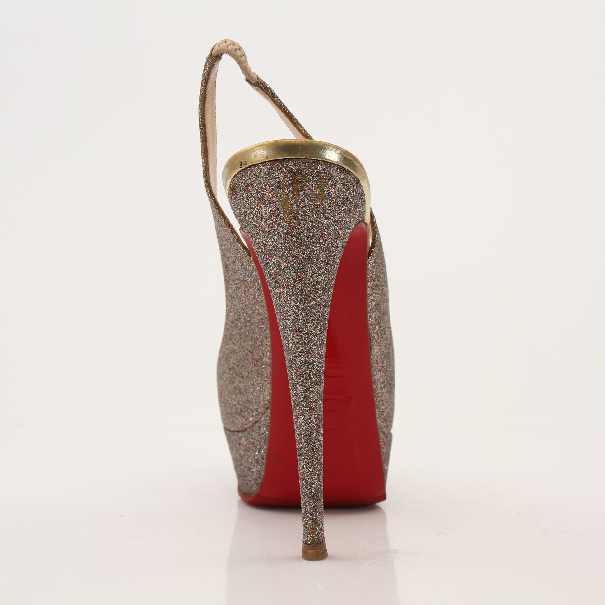 Christian Louboutin glitter slingback heels with red soles and elegant design, showcased on a neutral background.