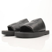 Black Burberry Knight Slab sandals by Gold & Beyond, featuring open-toe design and stylish leather straps.