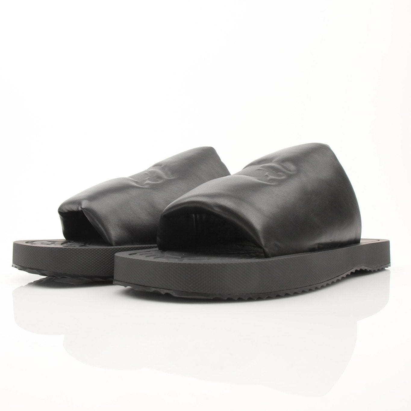 Black Burberry Knight Slab sandals by Gold & Beyond, featuring open-toe design and stylish leather straps.