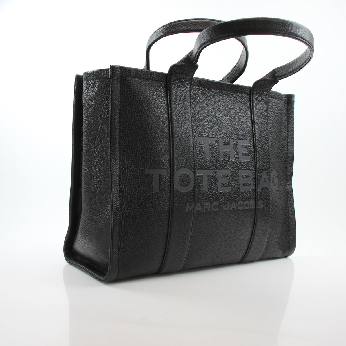 Black leather Marc Jacobs large tote handbag with structured design and top handles, stylish and spacious for everyday use.