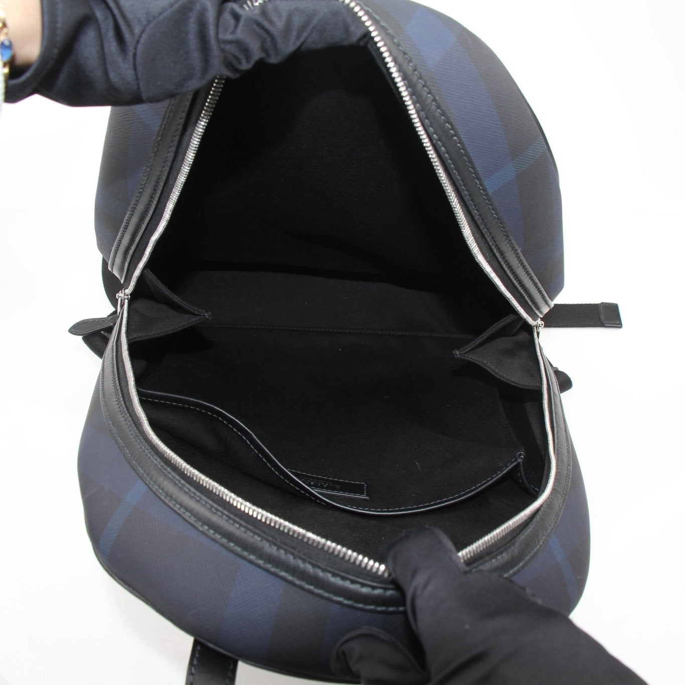 Gold & Beyond Burberry Blue Haymarket Check travel backpack with adjustable straps and multiple compartments.