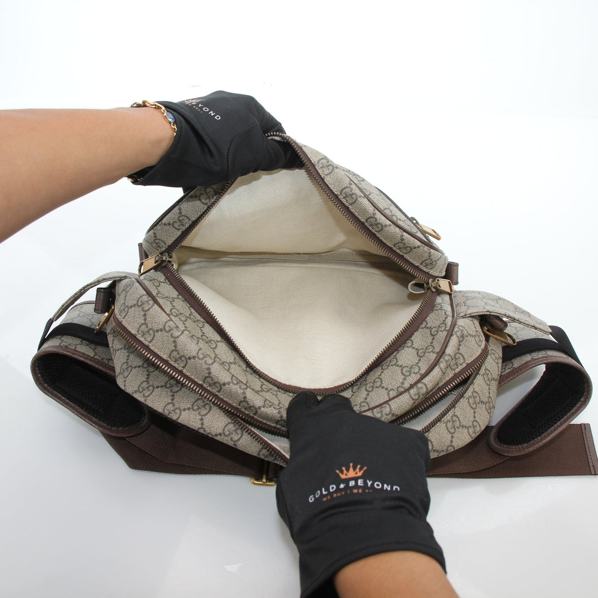 Gucci Ophidia GG Supreme medium belt bag in beige and ebony with adjustable strap and gold-tone hardware.