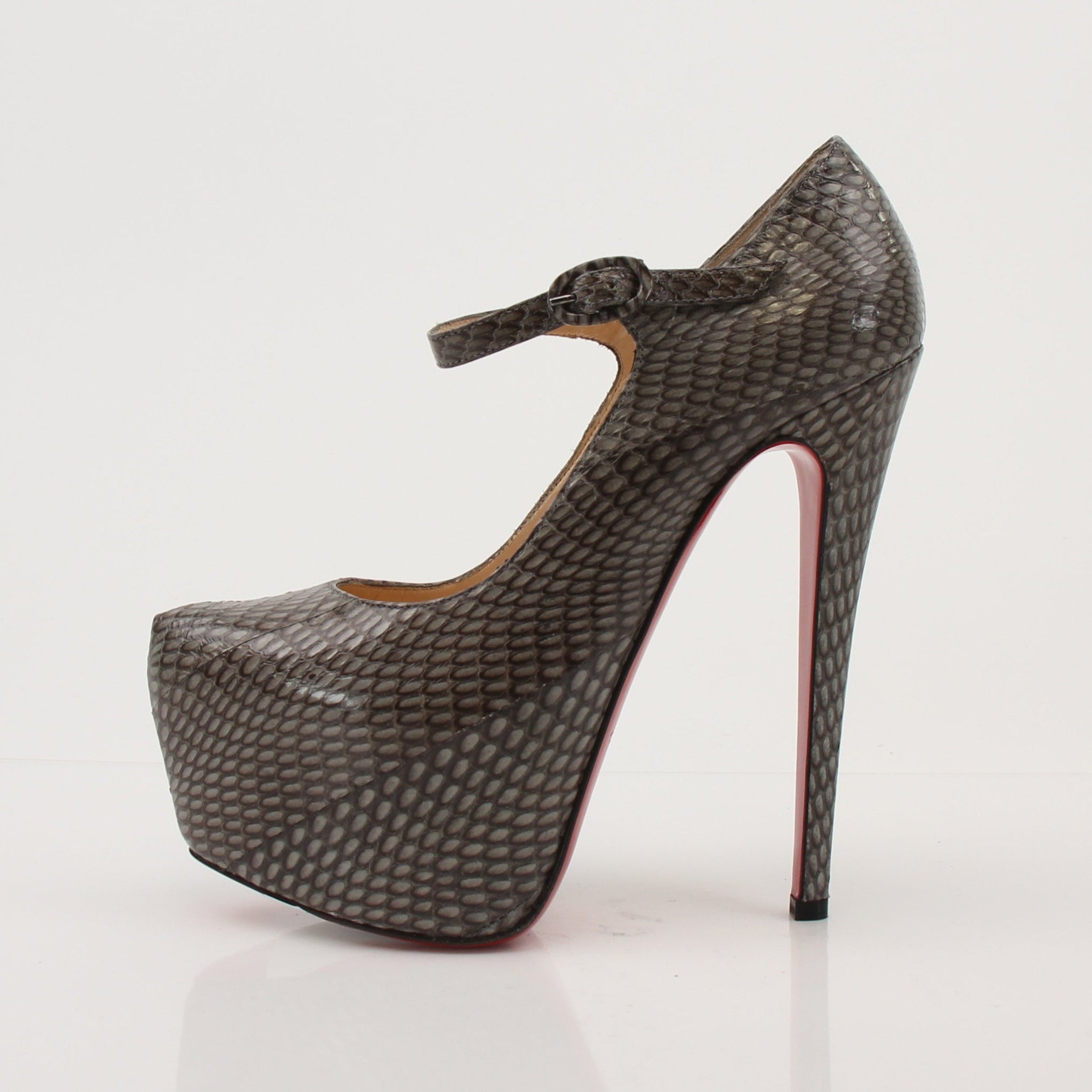 Christian Louboutin snakeskin platform heels with red soles and elegant design, showcased on a neutral background.