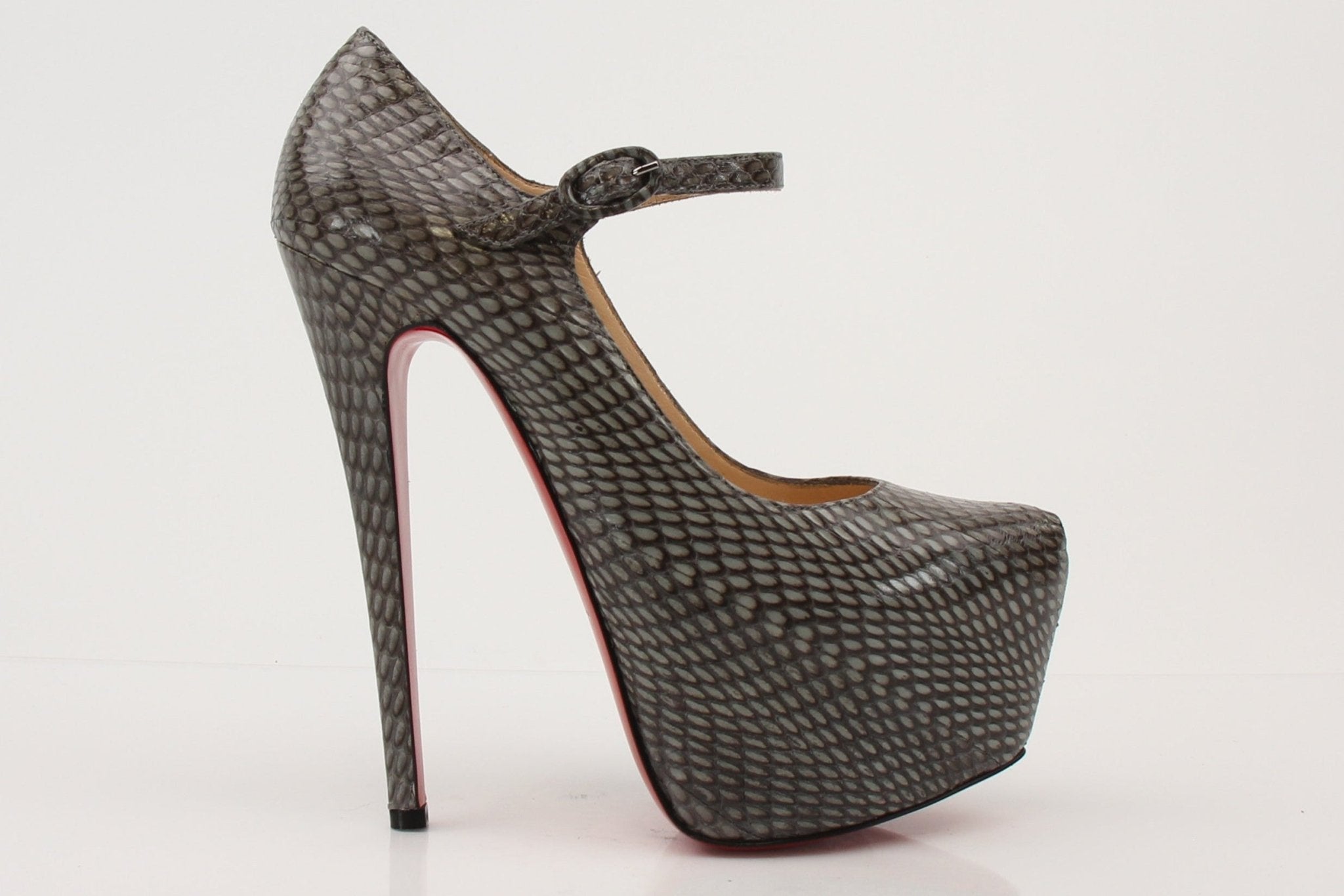 Christian Louboutin snakeskin platform heels with red soles, stylish and elegant, shown on a neutral background.