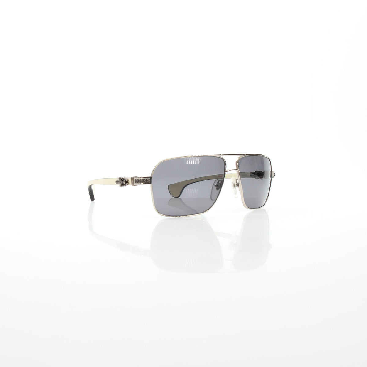 Chrome Hearts Throb aviator sunglasses with gold accents, resting on a white surface, showcasing their stylish, high-quality design.